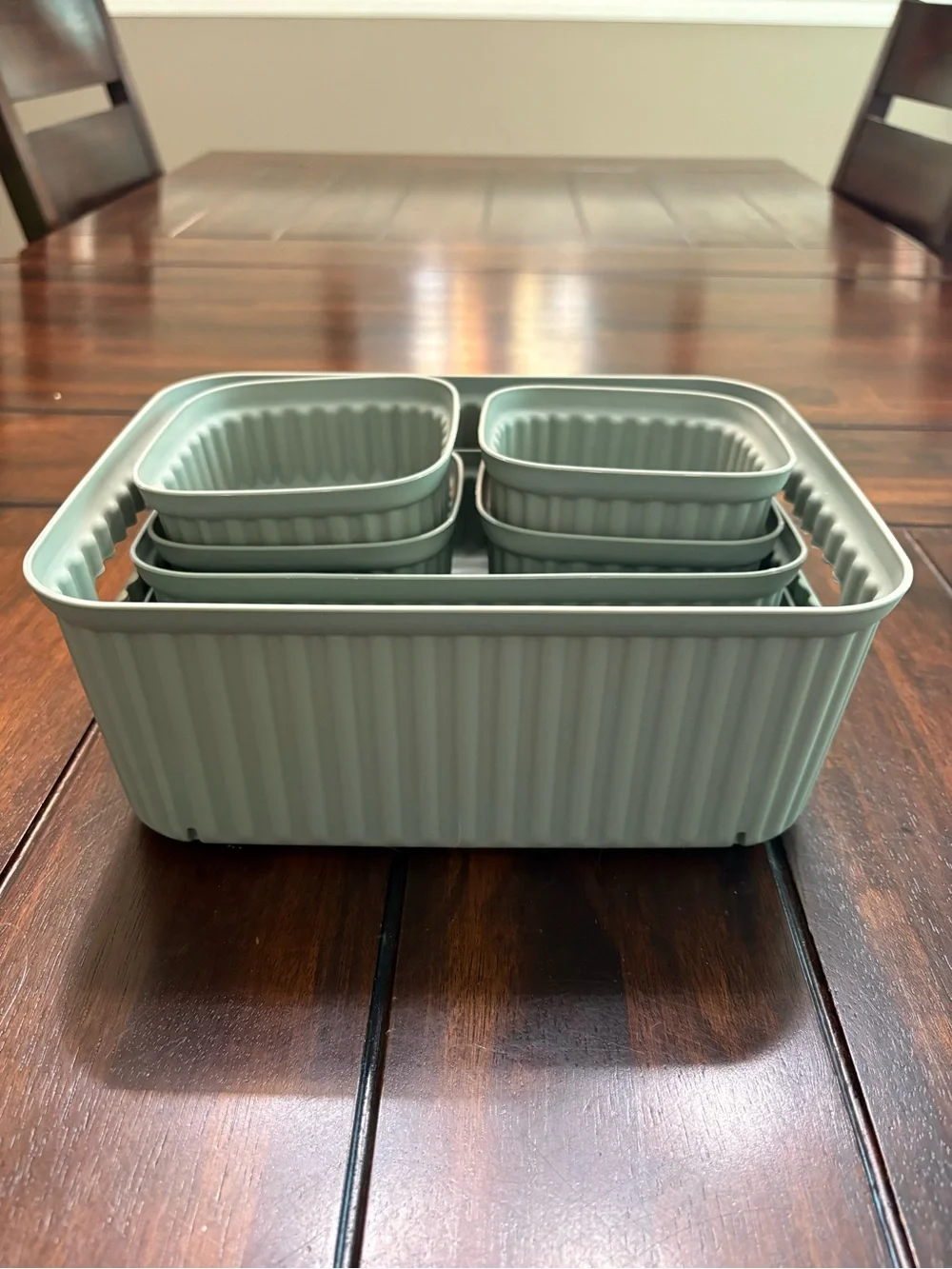 Set of 7 sage green plastic storage containers